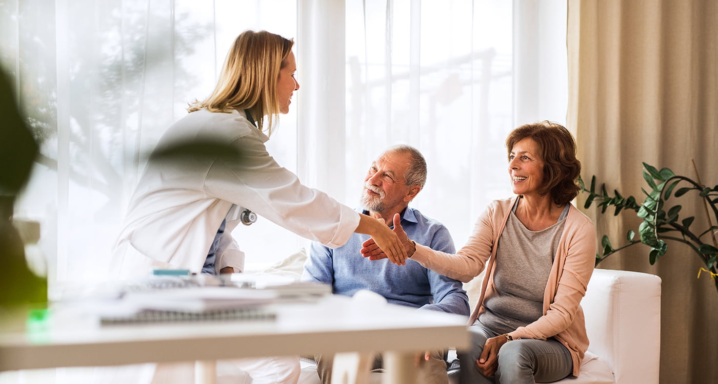 a doctor shaking hands with her patient